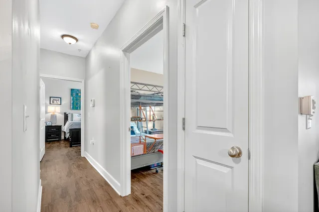 a view of a hallway with a livingroom and a bathroom