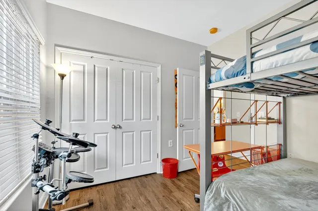 a bedroom with a bed and a window