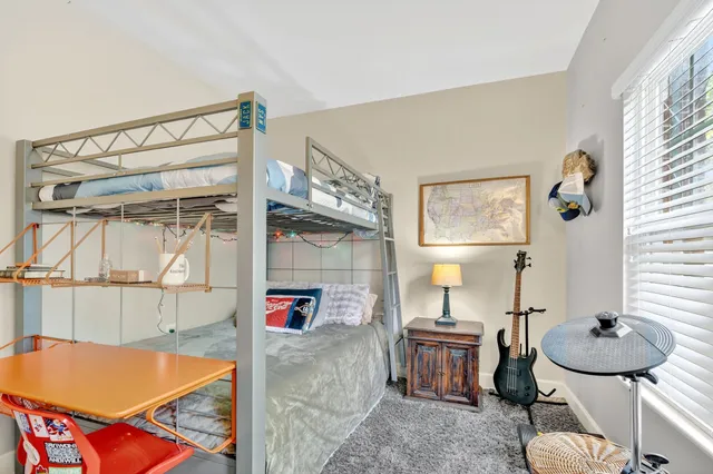a living room with furniture a rug and white walls