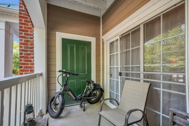a view of a chair and tables in the balcony