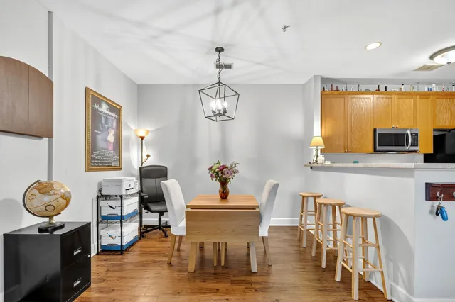 a dining room with furniture window and wooden floor