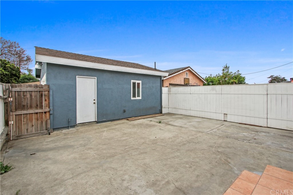 3655 Webster Avenue Long Beach, CA 90810 - Photo 19 of 22 a view of garage and wooden fence