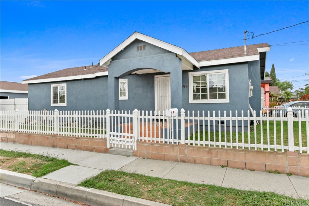 3655 Webster Avenue Long Beach, CA 90810 - Photo 2 of 22 a front view of a house with a garden