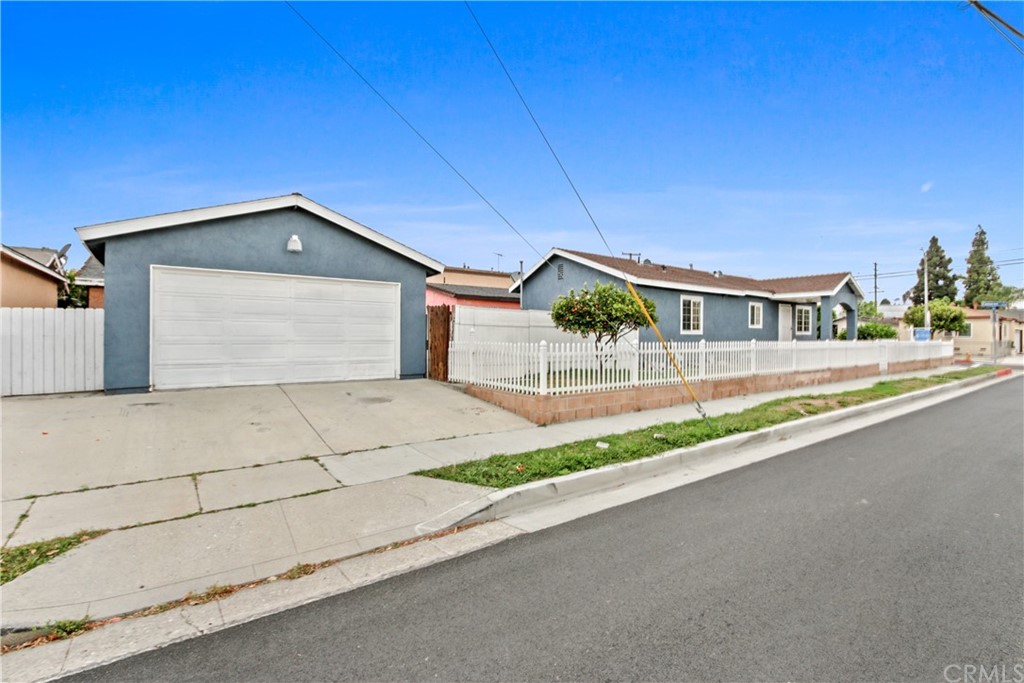 3655 Webster Avenue Long Beach, CA 90810 - Photo 21 of 22 a view of a house with a yard and garage