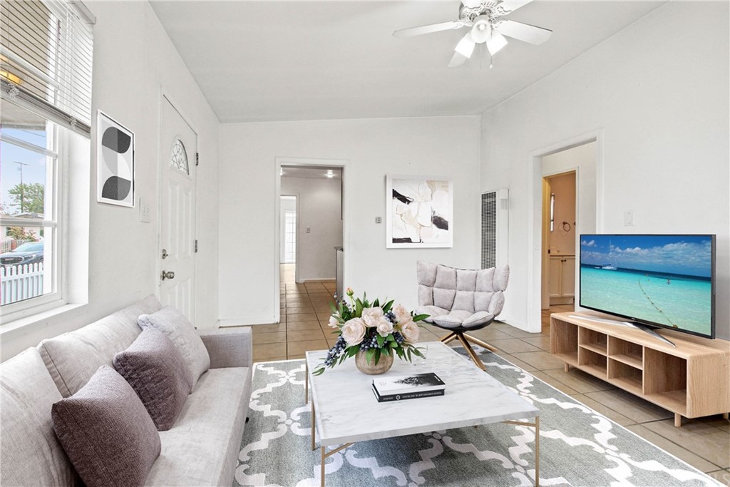 3655 Webster Avenue Long Beach, CA 90810 - Photo 4 of 22 a living room with furniture and a flat screen tv