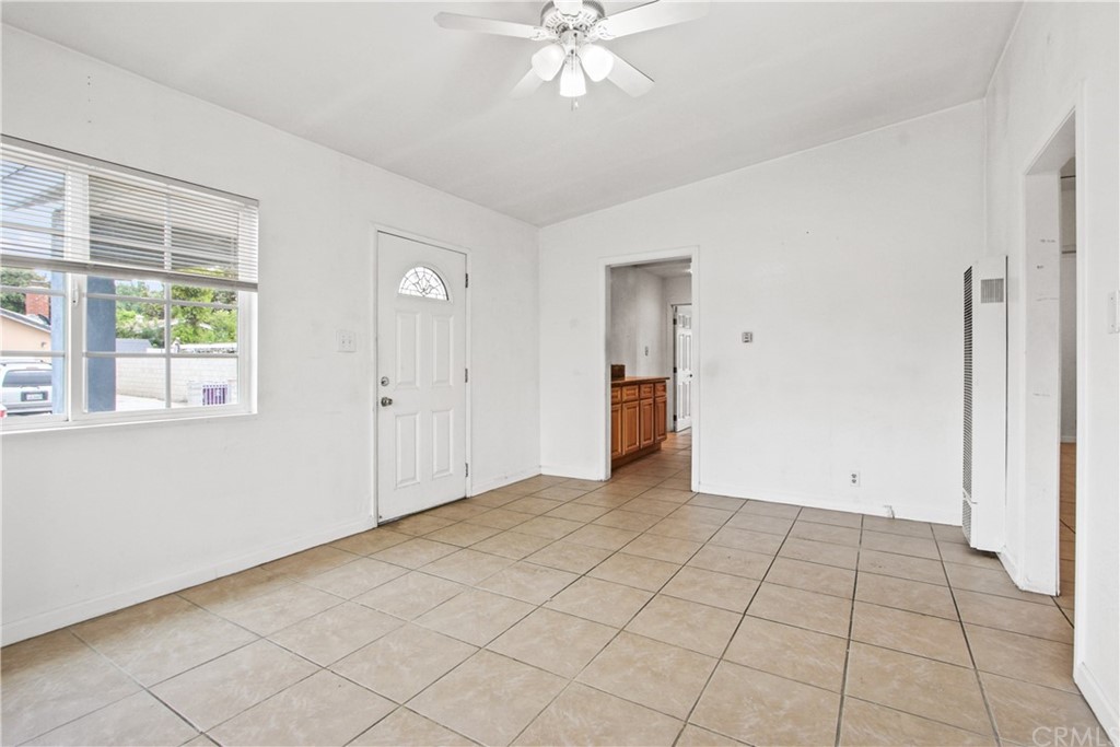 3655 Webster Avenue Long Beach, CA 90810 - Photo 5 of 22 a view of an empty room with window and chandelier fan