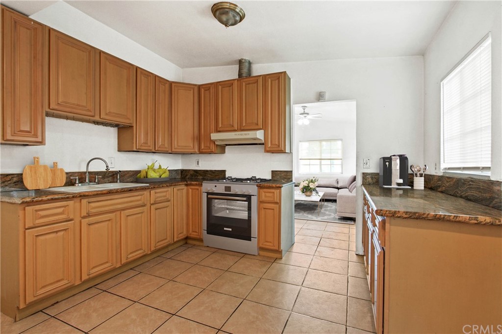 3655 Webster Avenue Long Beach, CA 90810 - Photo 6 of 22 a kitchen with a sink stove and cabinets