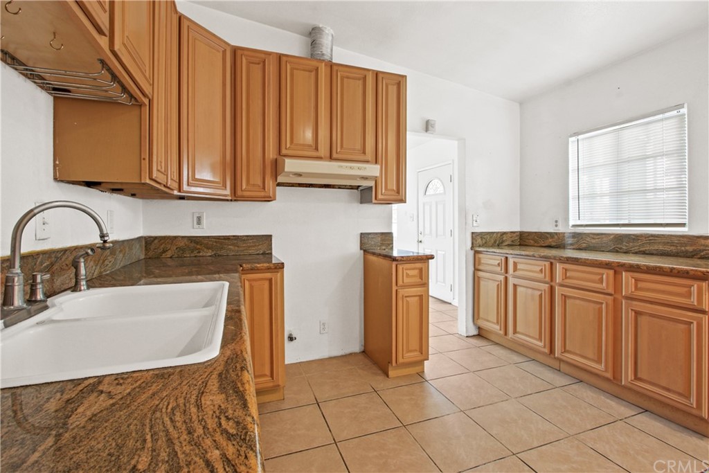 3655 Webster Avenue Long Beach, CA 90810 - Photo 7 of 22 a kitchen with a sink refrigerator and cabinets