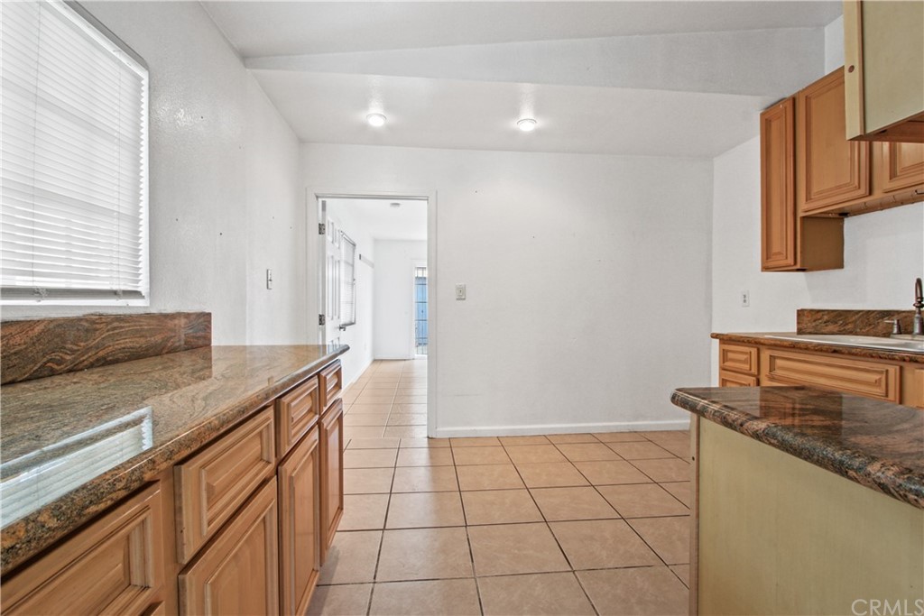 3655 Webster Avenue Long Beach, CA 90810 - Photo 8 of 22 a kitchen with a sink and cabinets