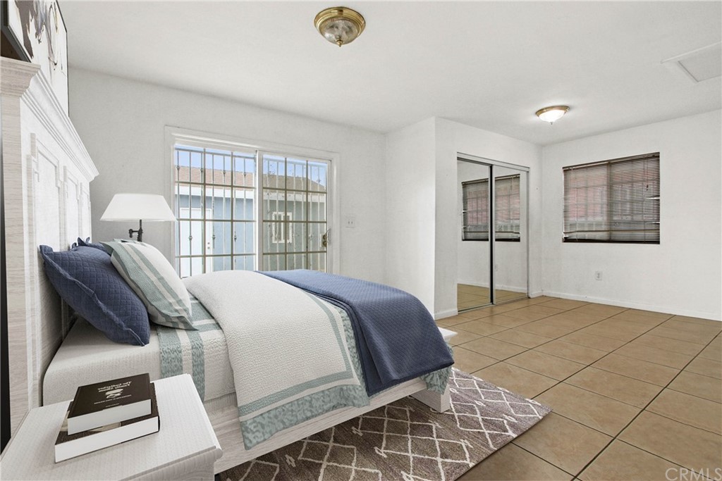 3655 Webster Avenue Long Beach, CA 90810 - Photo 9 of 22 a bedroom with a bed and a window