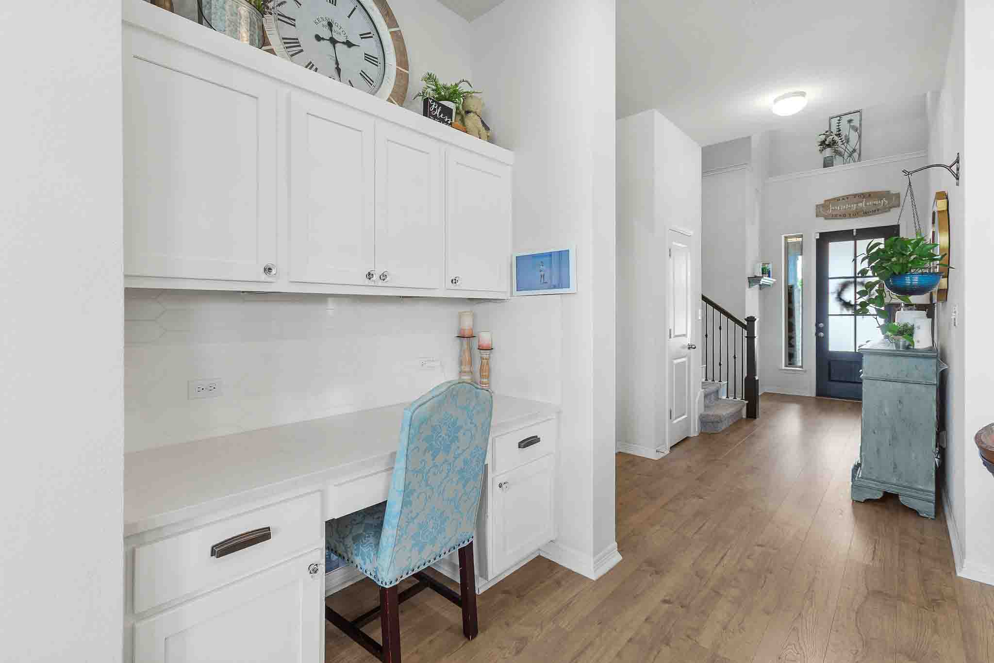 166 West Branch Road Kyle, TX 78640 - Photo 20 of 39 A well-lit entryway greets visitors with warm wood flooring and a convenient built-in desk area.