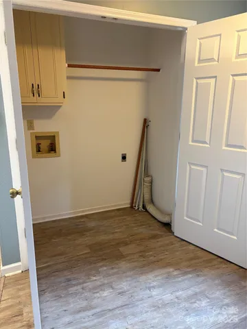 a view of a room with wooden floor and cabinet