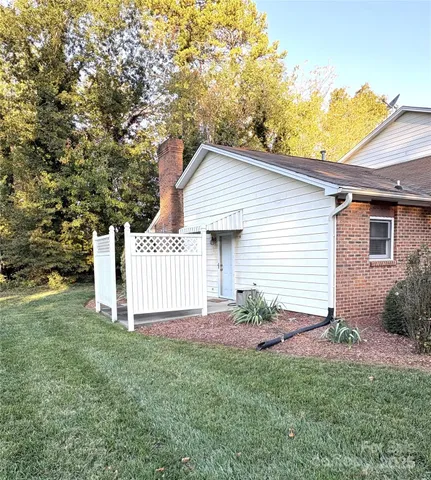 a front view of a house with a garden and yard