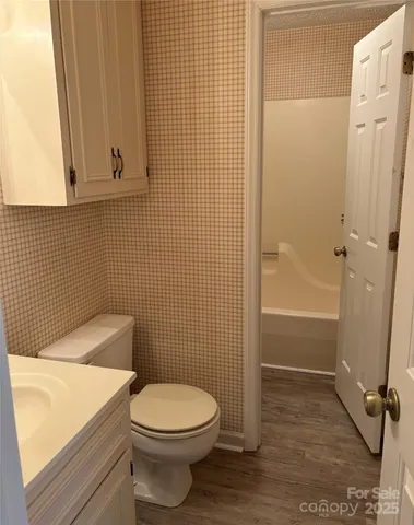 a bathroom with a toilet and shower