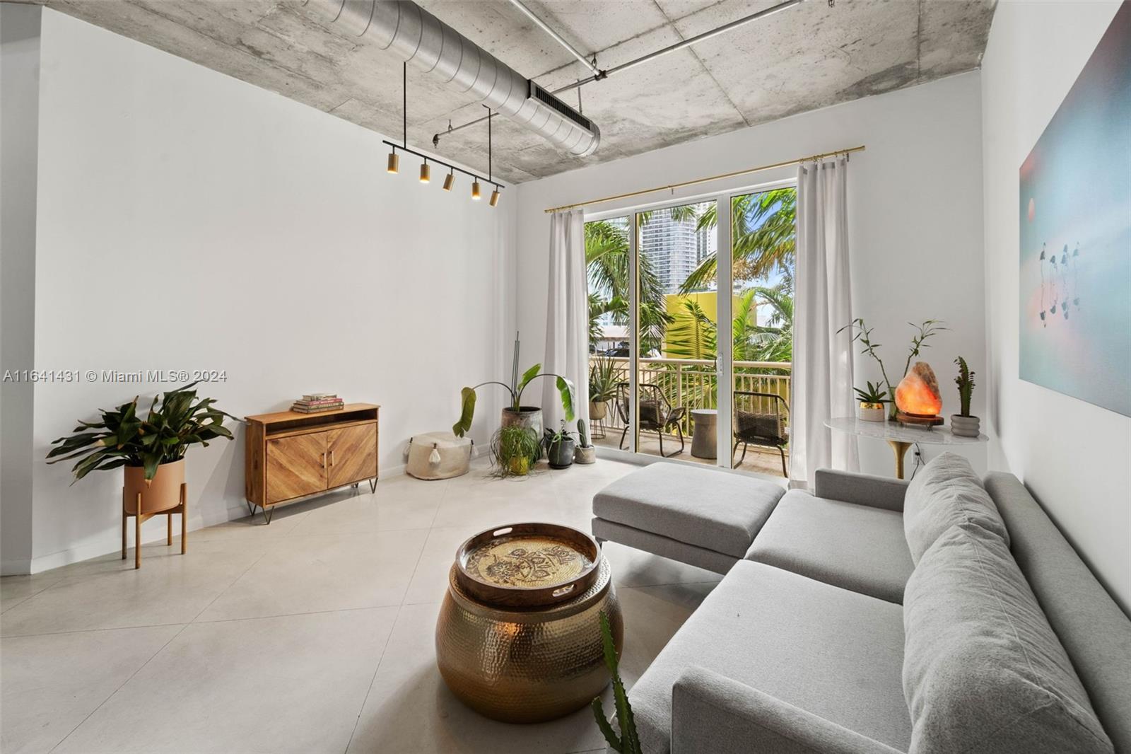 2001 Biscayne Boulevard, Unit 2409 Miami, FL 33137 - Photo 2 of 29 a living room with furniture and a large window