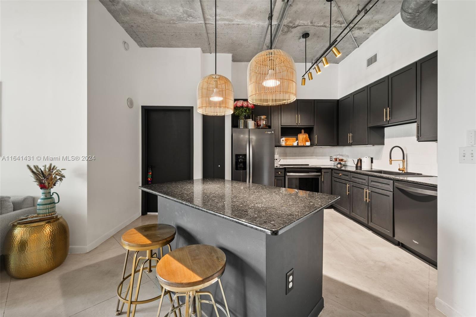 2001 Biscayne Boulevard, Unit 2409 Miami, FL 33137 - Photo 6 of 29 a kitchen with stainless steel appliances granite countertop a sink a stove and a wooden floors