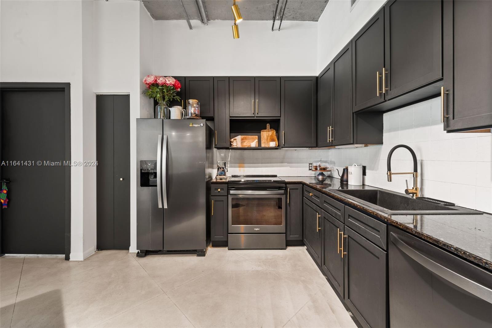 2001 Biscayne Boulevard, Unit 2409 Miami, FL 33137 - Photo 7 of 29 a kitchen with stainless steel appliances granite countertop a refrigerator sink and stove