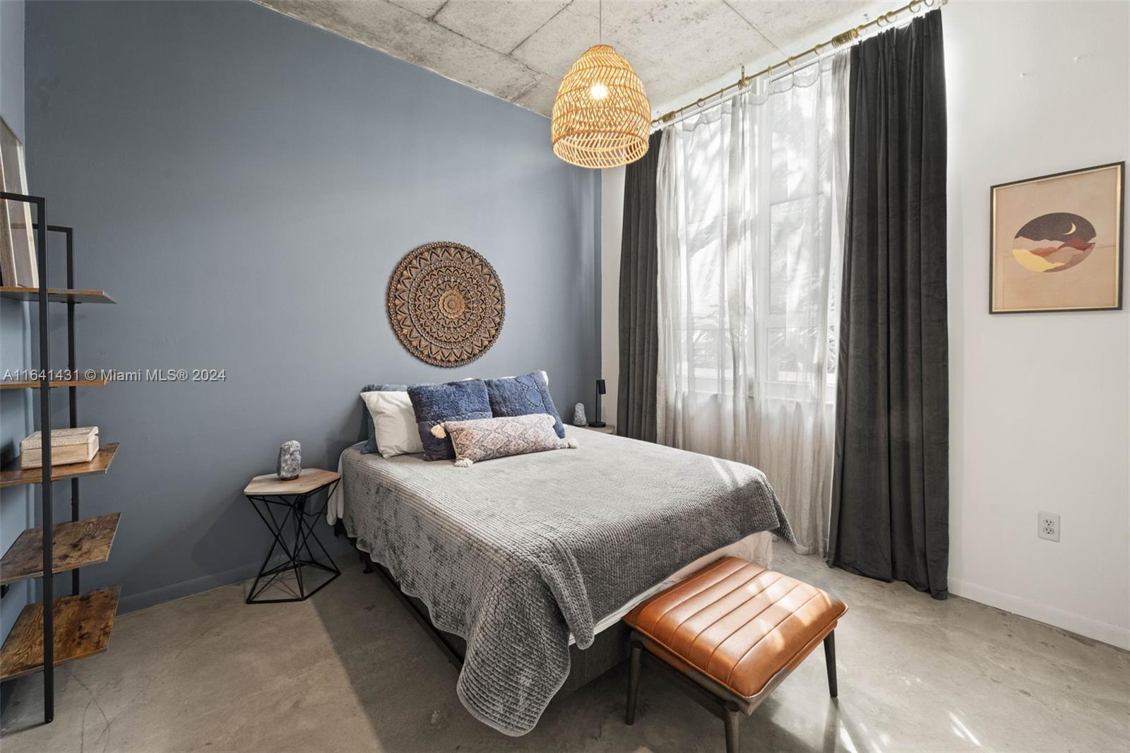 2001 Biscayne Boulevard, Unit 2409 Miami, FL 33137 - Photo 10 of 29 a bedroom with a bed and a chandelier