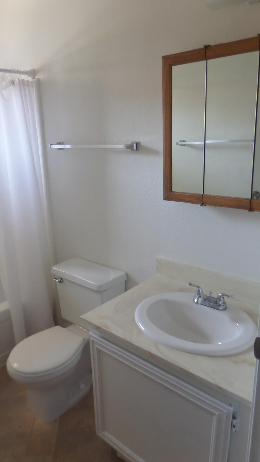 72631 Thrush Road, Unit 4 Palm Desert, CA 92260 - Photo 11 of 24 a white toilet sitting next to a bathroom sink