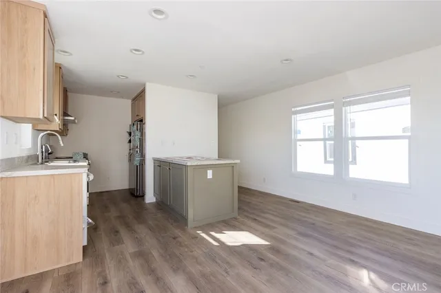 a view of a kitchen with wooden floor and a sink