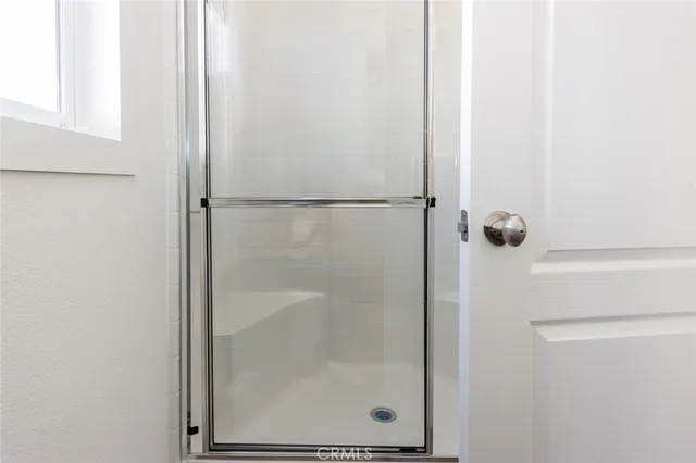 a bathroom with a glass shower door