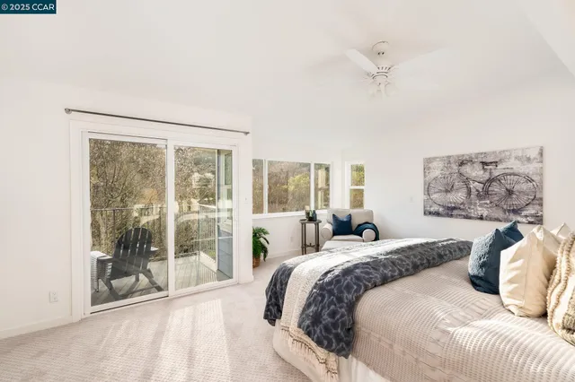 a bedroom with a large bed and a large window