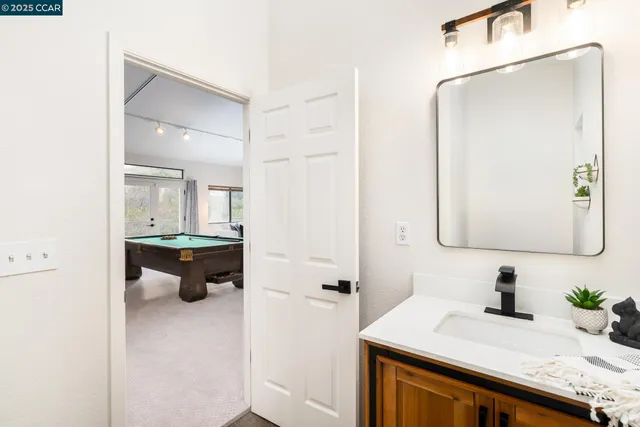a bathroom with a granite countertop sink mirror and vanity