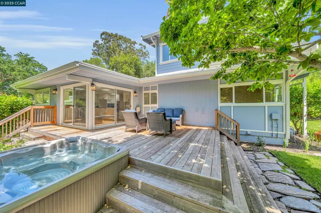 a view of a house with backyard sitting area and garden