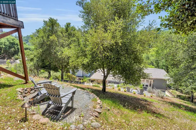 a view of a patio with table and chairs and potted plants