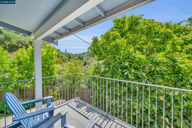 a view of a balcony with chair and wooden fence