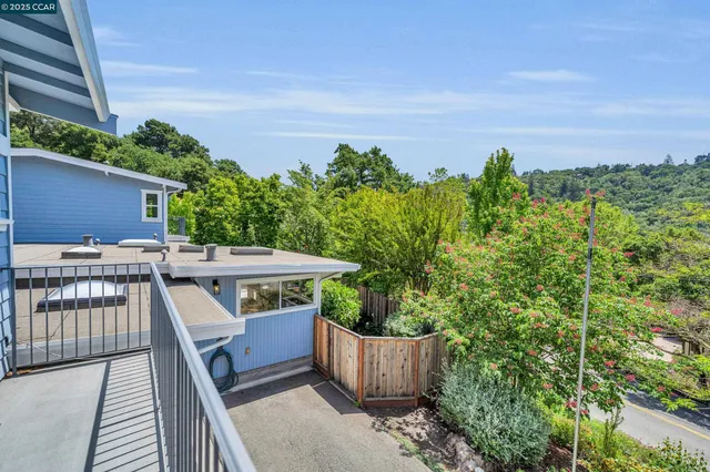 a view of a balcony with wooden floor and outdoor seating