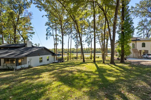 a swimming pool with trees in the background