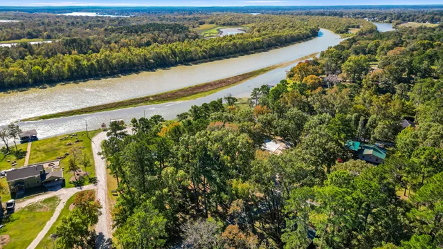 an aerial view of a house with a yard and lake view
