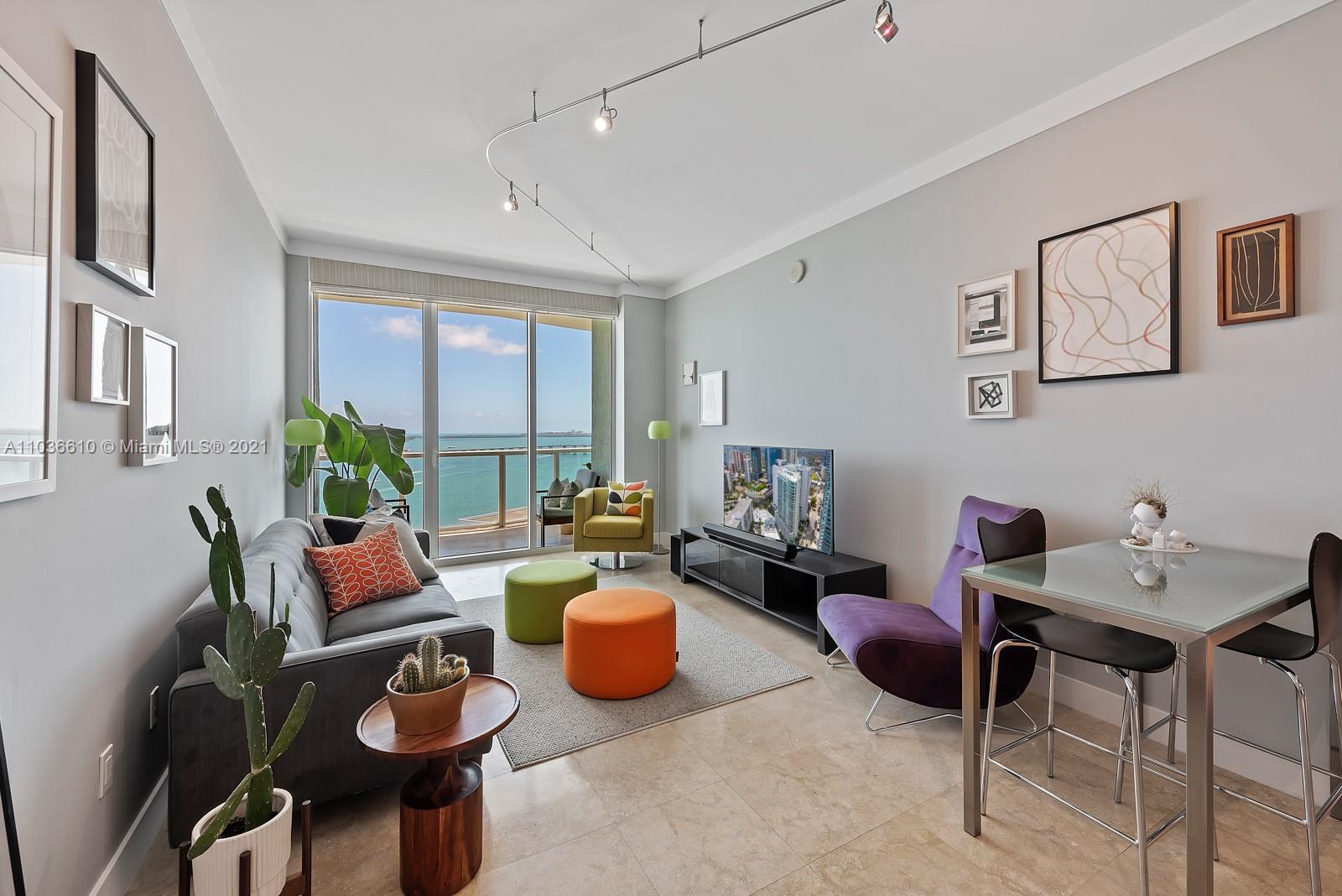 218 Southeast 14th Street, Unit TS103 Miami, FL 33131 - Photo 1 of 31 a living room with furniture and a potted plant