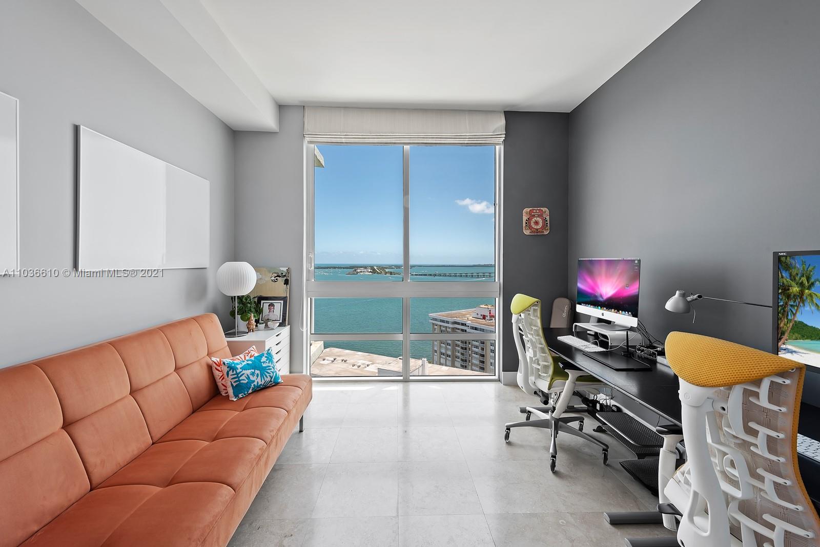 218 Southeast 14th Street, Unit TS103 Miami, FL 33131 - Photo 11 of 31 a living room with furniture and a lamp