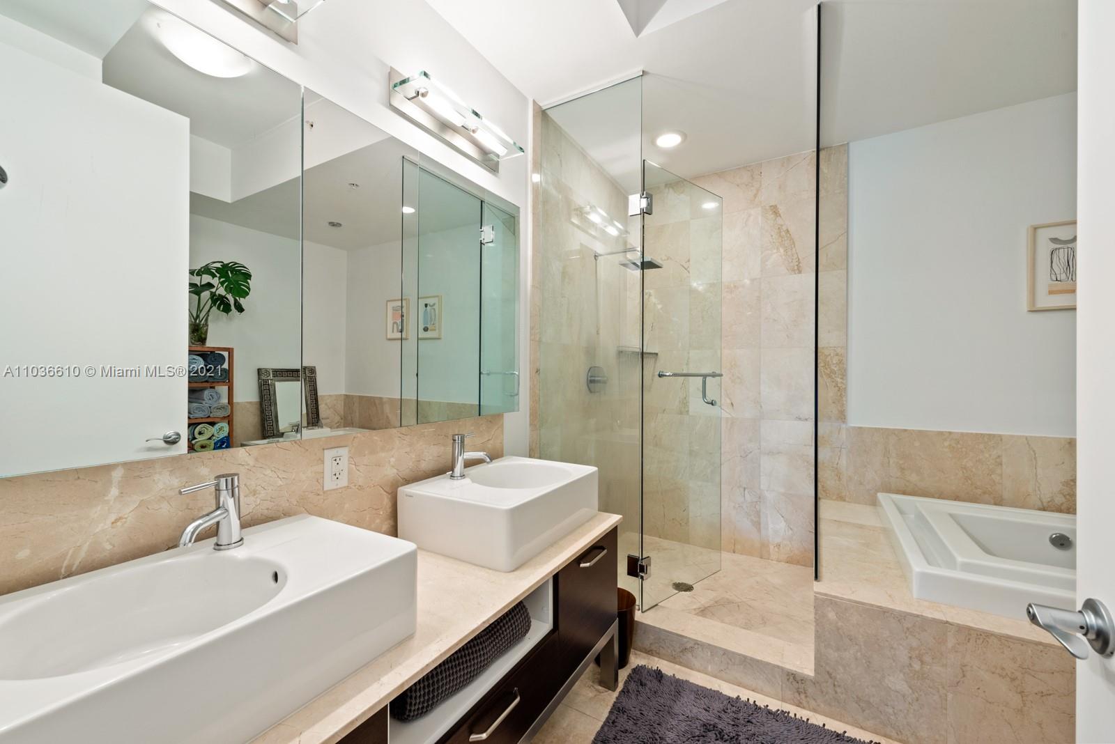 218 Southeast 14th Street, Unit TS103 Miami, FL 33131 - Photo 13 of 31 a spacious bathroom with a bathtub shower sink and mirror