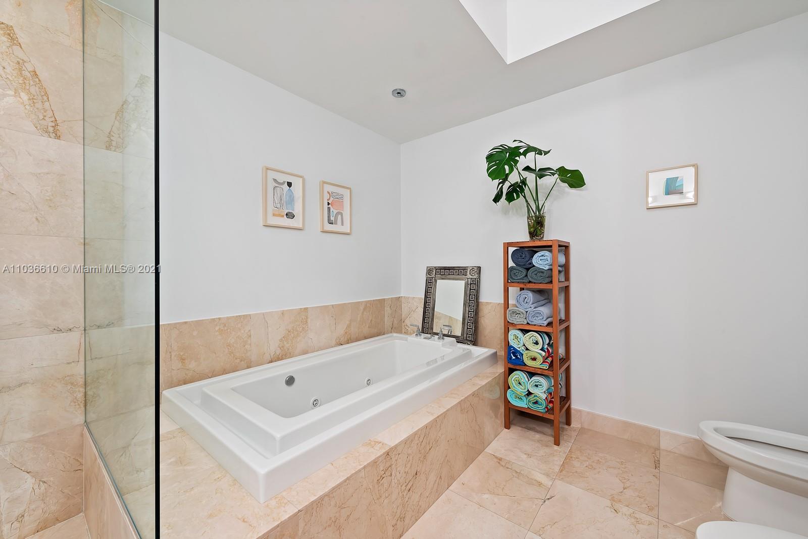 218 Southeast 14th Street, Unit TS103 Miami, FL 33131 - Photo 14 of 31 a bathroom with a bathtub and a potted plant
