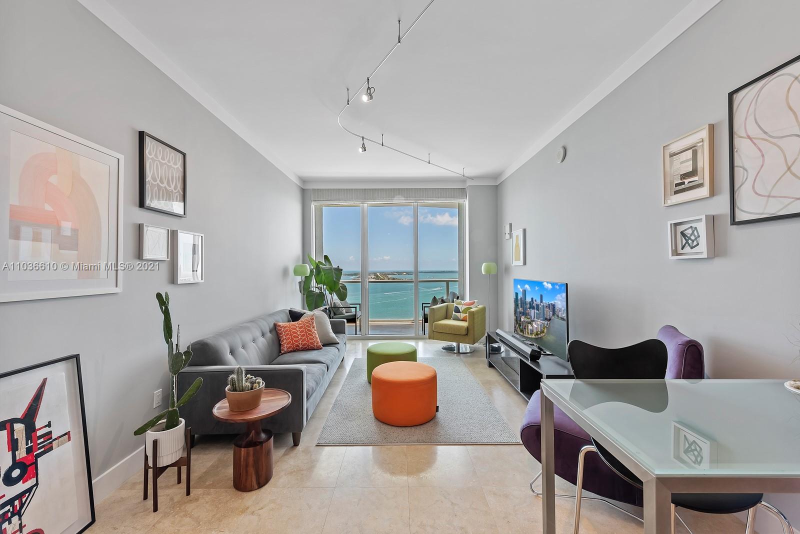218 Southeast 14th Street, Unit TS103 Miami, FL 33131 - Photo 2 of 31 a living room with furniture a rug and a table