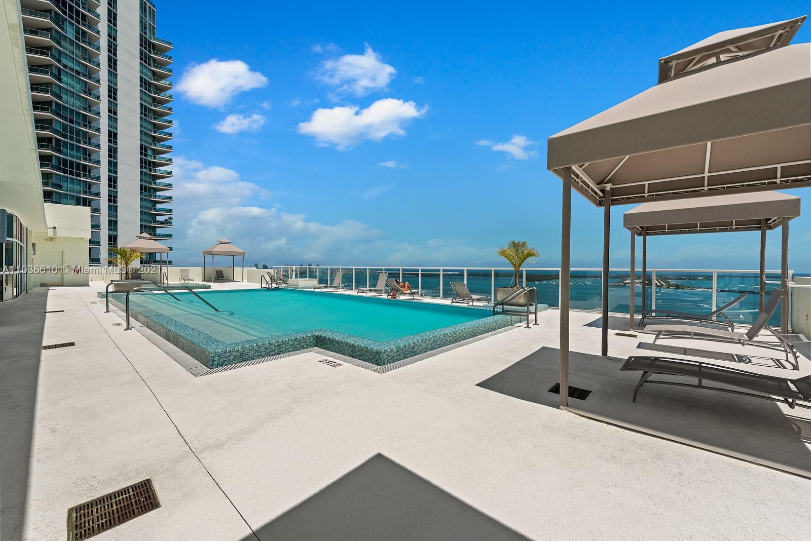 218 Southeast 14th Street, Unit TS103 Miami, FL 33131 - Photo 23 of 31 a view of a house with a swimming pool