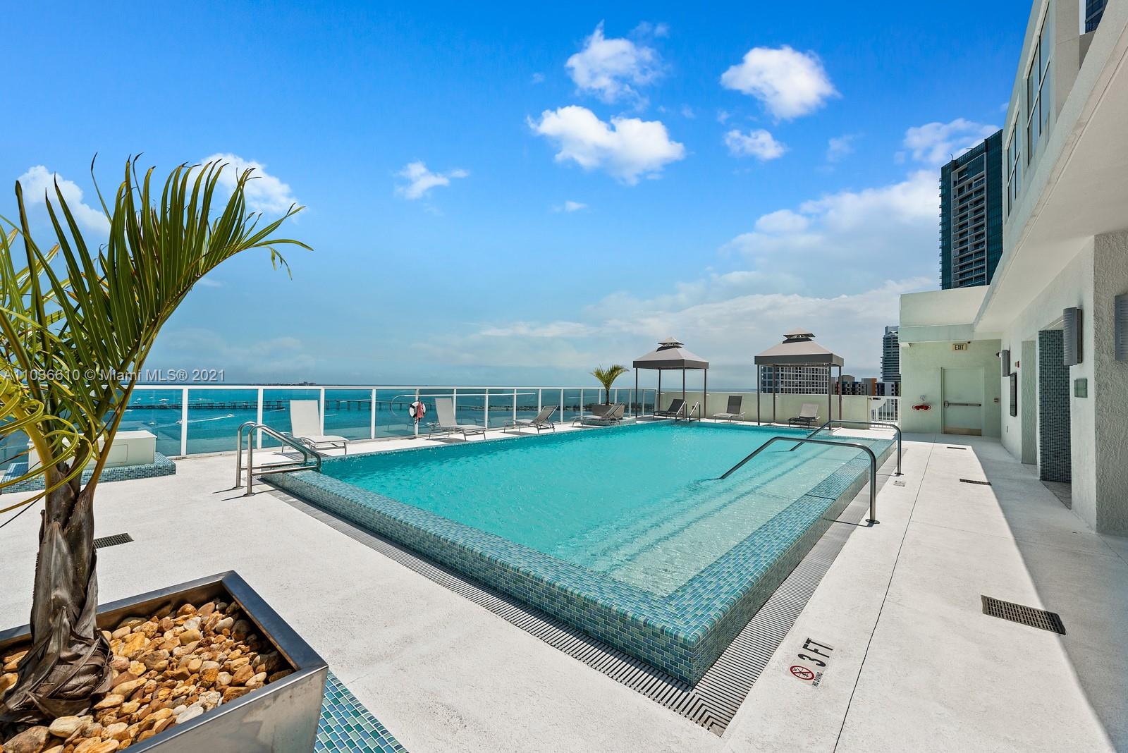 218 Southeast 14th Street, Unit TS103 Miami, FL 33131 - Photo 26 of 31 a view of a swimming pool with a patio and a yard