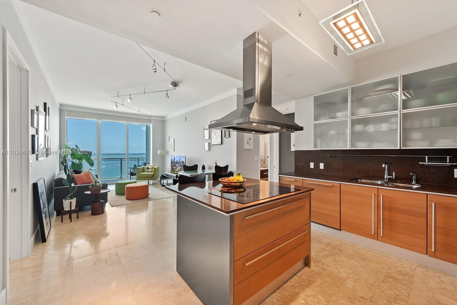 218 Southeast 14th Street, Unit TS103 Miami, FL 33131 - Photo 5 of 31 a kitchen with stainless steel appliances granite countertop a sink and a stove