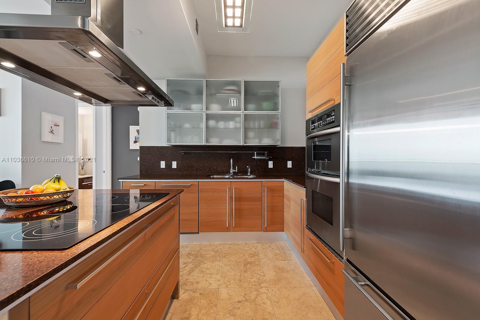 218 Southeast 14th Street, Unit TS103 Miami, FL 33131 - Photo 6 of 31 a kitchen with stainless steel appliances granite countertop a refrigerator and a stove top oven