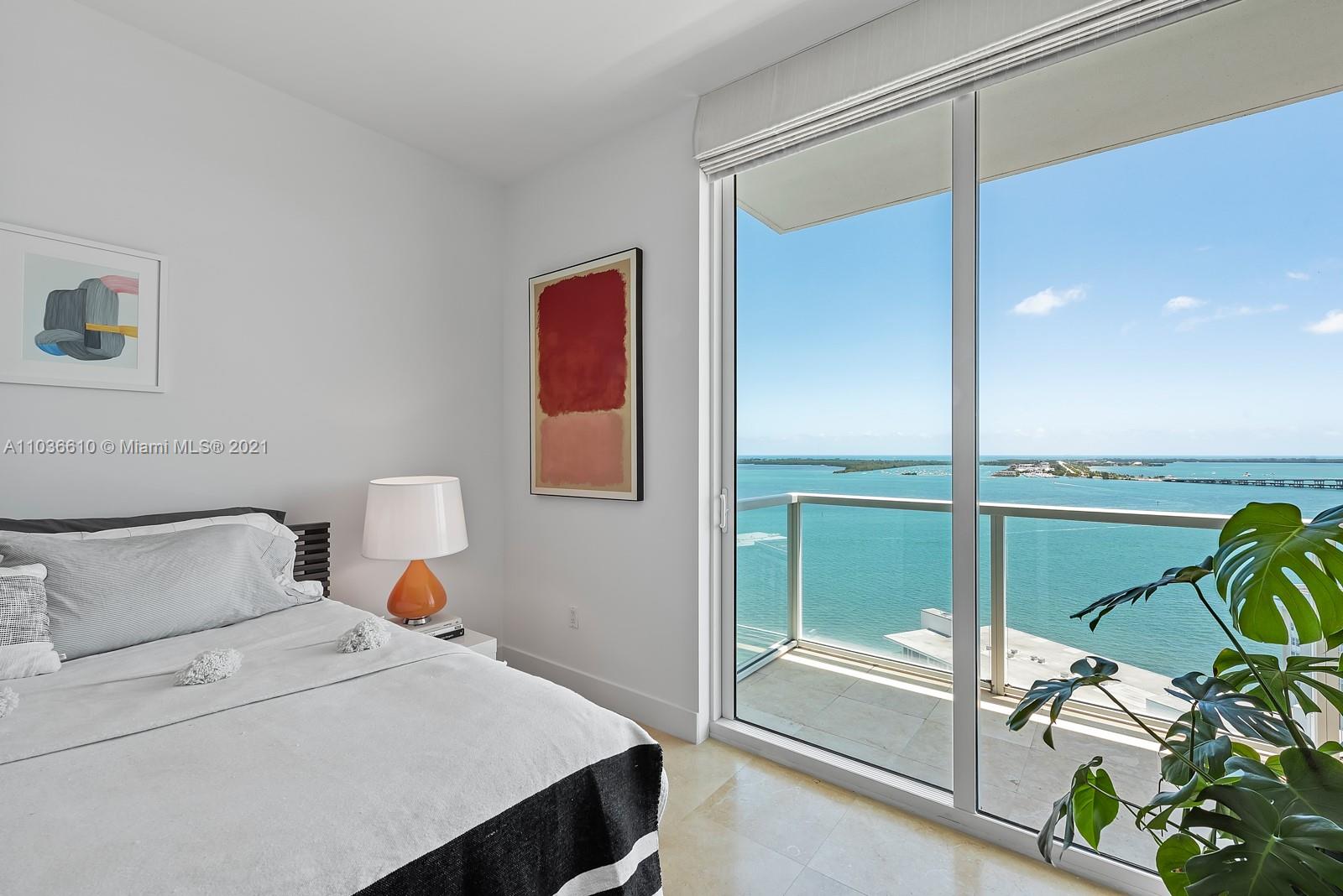 218 Southeast 14th Street, Unit TS103 Miami, FL 33131 - Photo 9 of 31 a bedroom with a bed and a chandelier