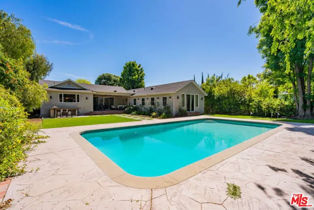 a view of a swimming pool with an outdoor seating area