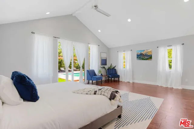 a bed room with a bed and a chair