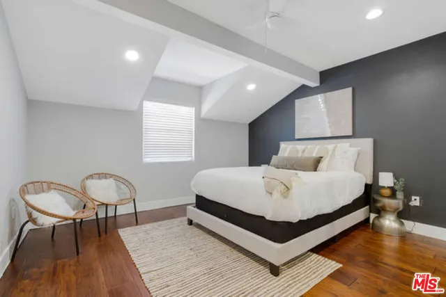 a bed room with a bed and a chair