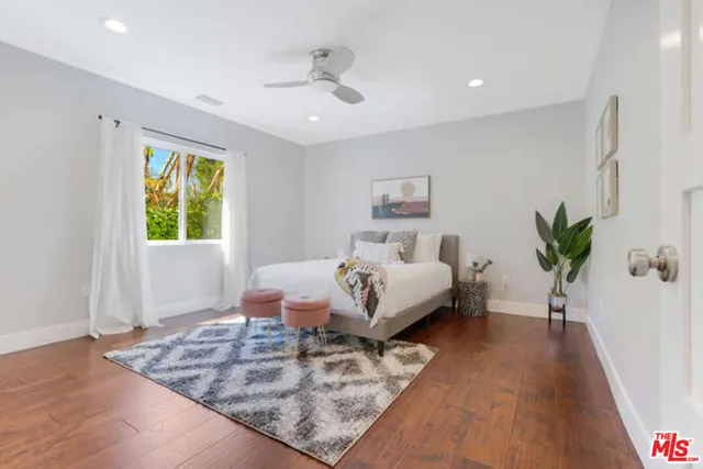 a bed room with a bed and a potted plant