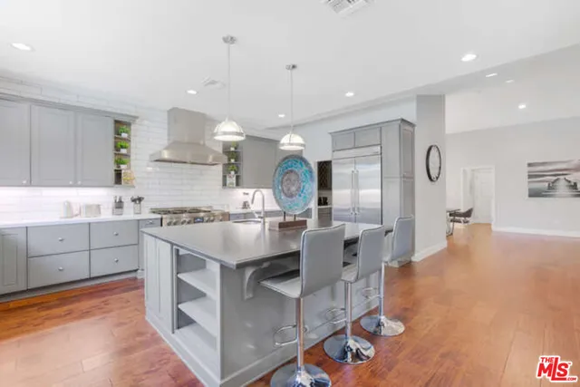 a large kitchen with kitchen island a sink appliances and cabinets