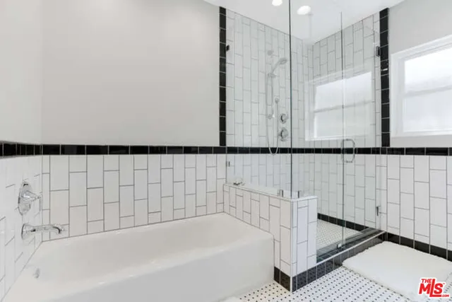 a bathroom with a bathtub and a shower