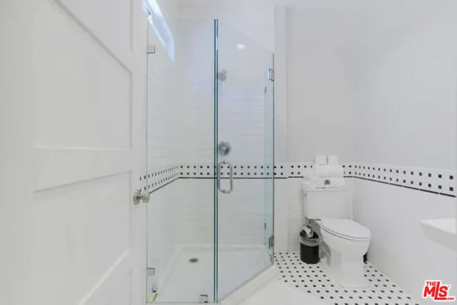 a bathroom with a toilet a sink and a shower